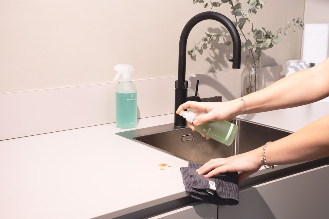 why-choose-us a-woman-is-cleaning-a-kitchen-sink-with-a-rag-sqomdoqb3ws